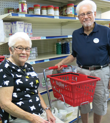 Len and Jo Roberts in The Crisis Center Food Bank during a recent volunteer shift.