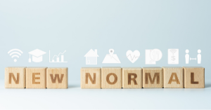 An image featuring wooden playing blocks together spelling the phrase "NEW NORMAL"