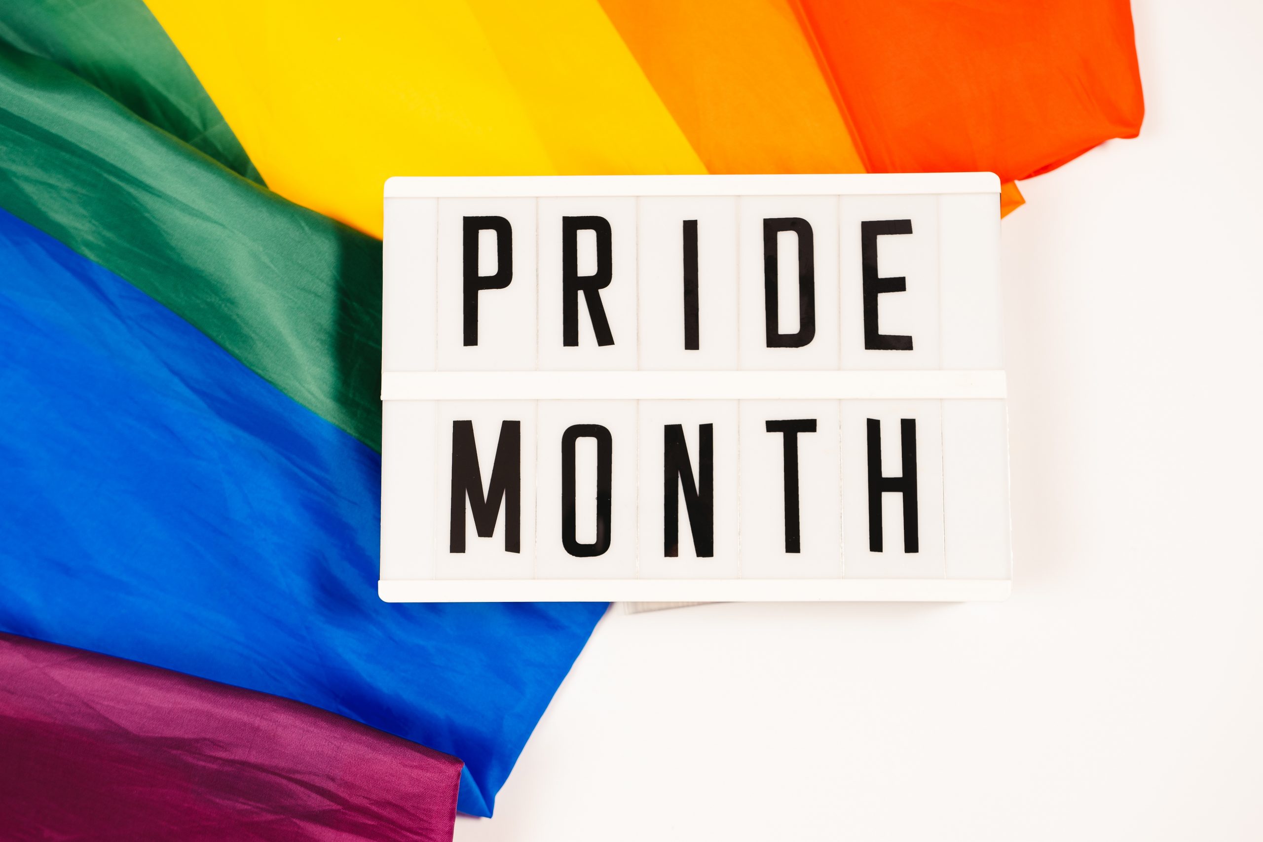 Rainbow Flag behind the words "Pride Month"